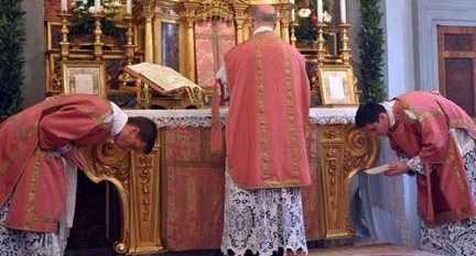 bowing men in pink vestments